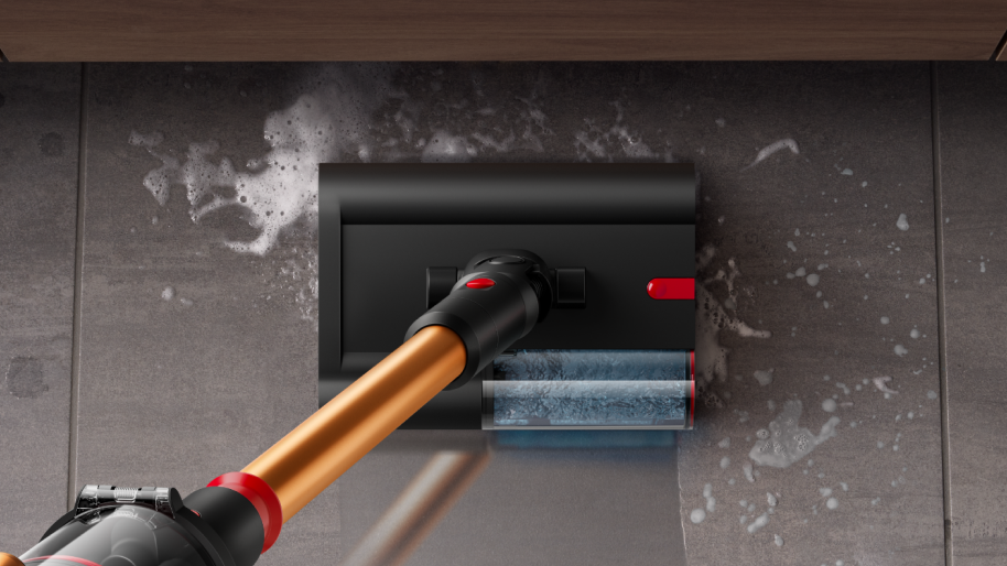 Woman vacuuming living room floor with Dyson vacuum